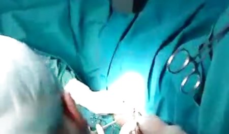 Young girl agrees to suck the phallus through a hole in the wall and the dick of the guy standing next to